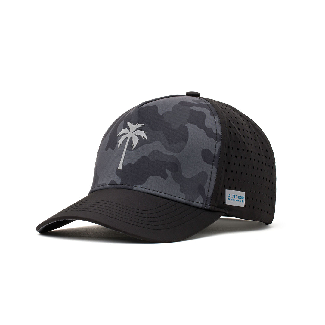 Angled view of a black and camo performance hat showcasing a white palm tree logo, curved brim, and sweat-wicking material for all-day comfort.
