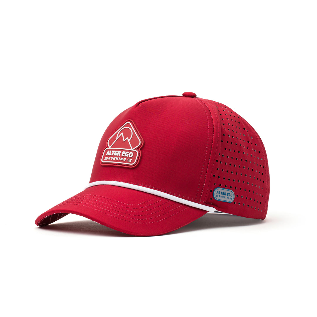 Angled view of a red performance hat featuring a white mountain logo, lightweight construction, and curved brim for style and function during outdoor activities.