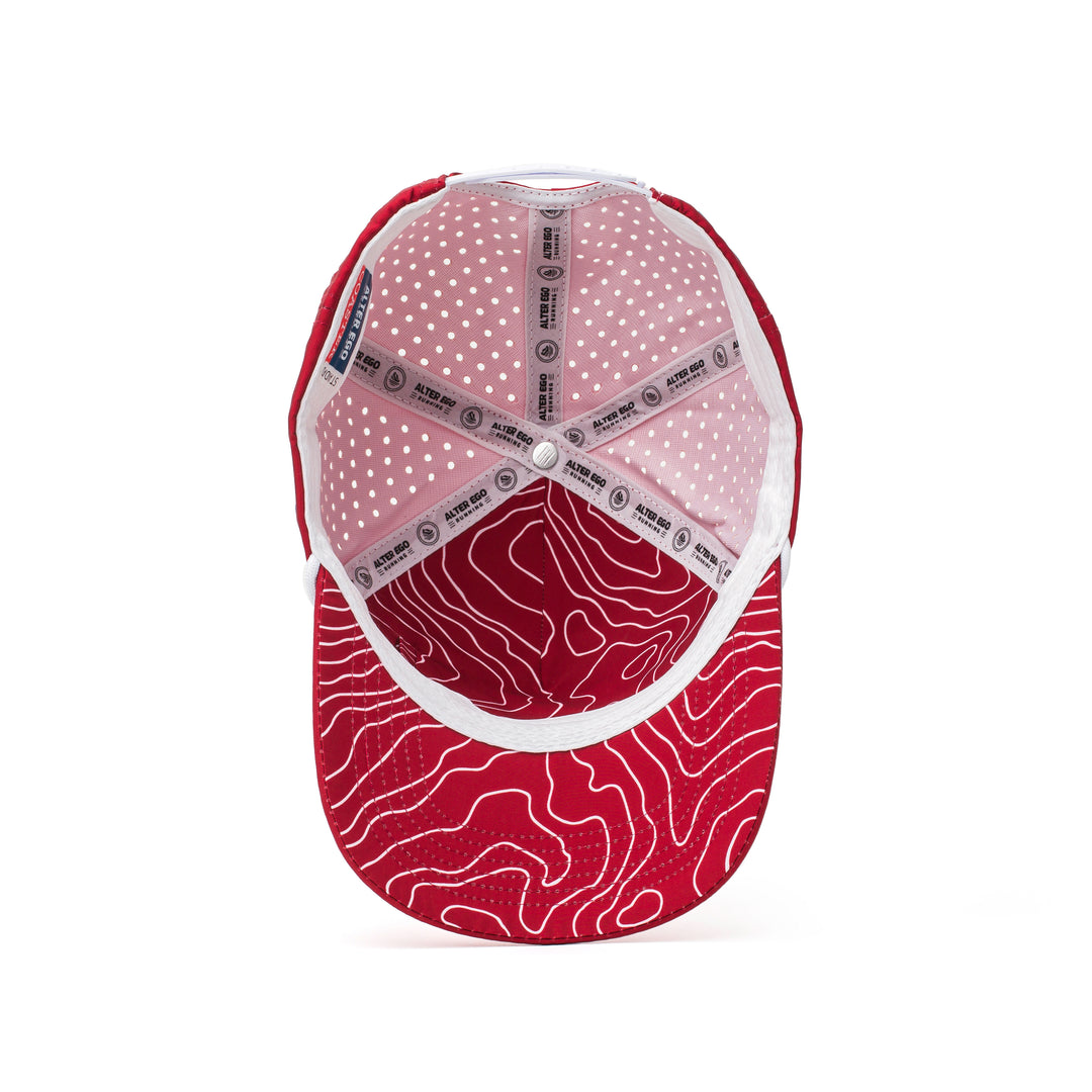 Interior and back view of a red cap with a white patterned mesh panel, adjustable strap, and perforated sides for maximum airflow and comfort.