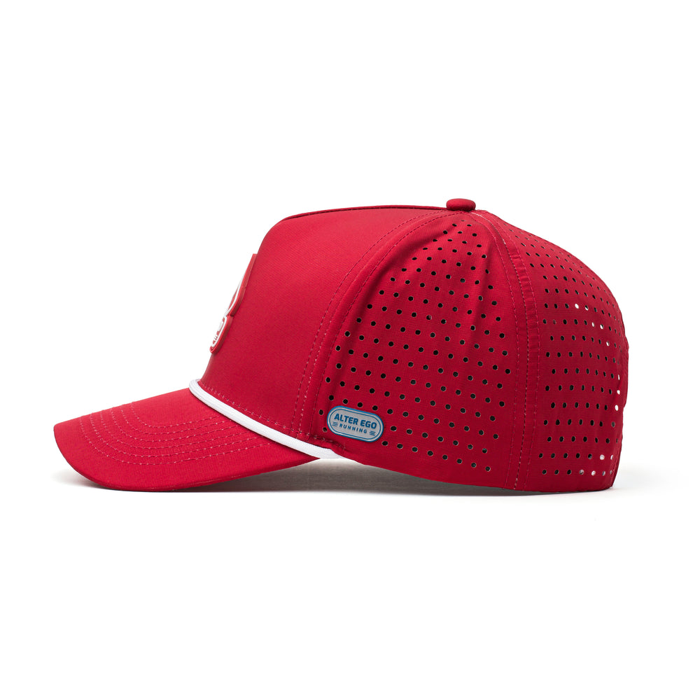 Side view of a red hat featuring a white mountain emblem, curved brim, and perforated panels for breathability and lightweight comfort.